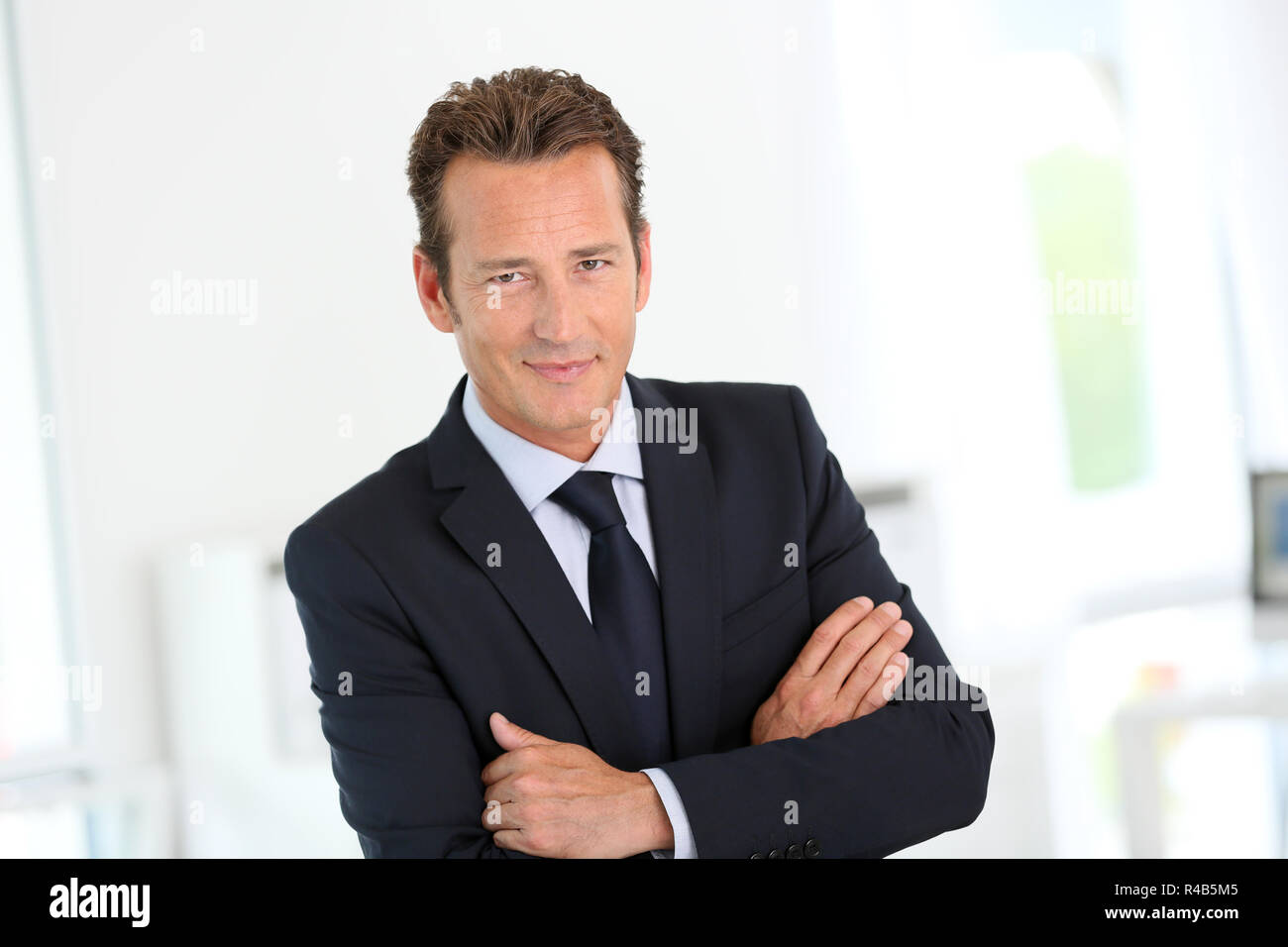 Confident businessman looking at camera Stock Photo - Alamy