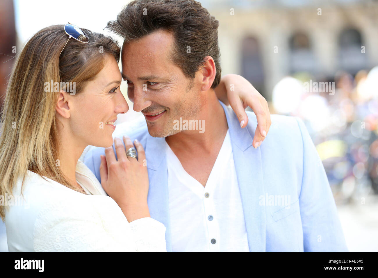 Fancy loving couple in town embracing each other Stock Photo - Alamy