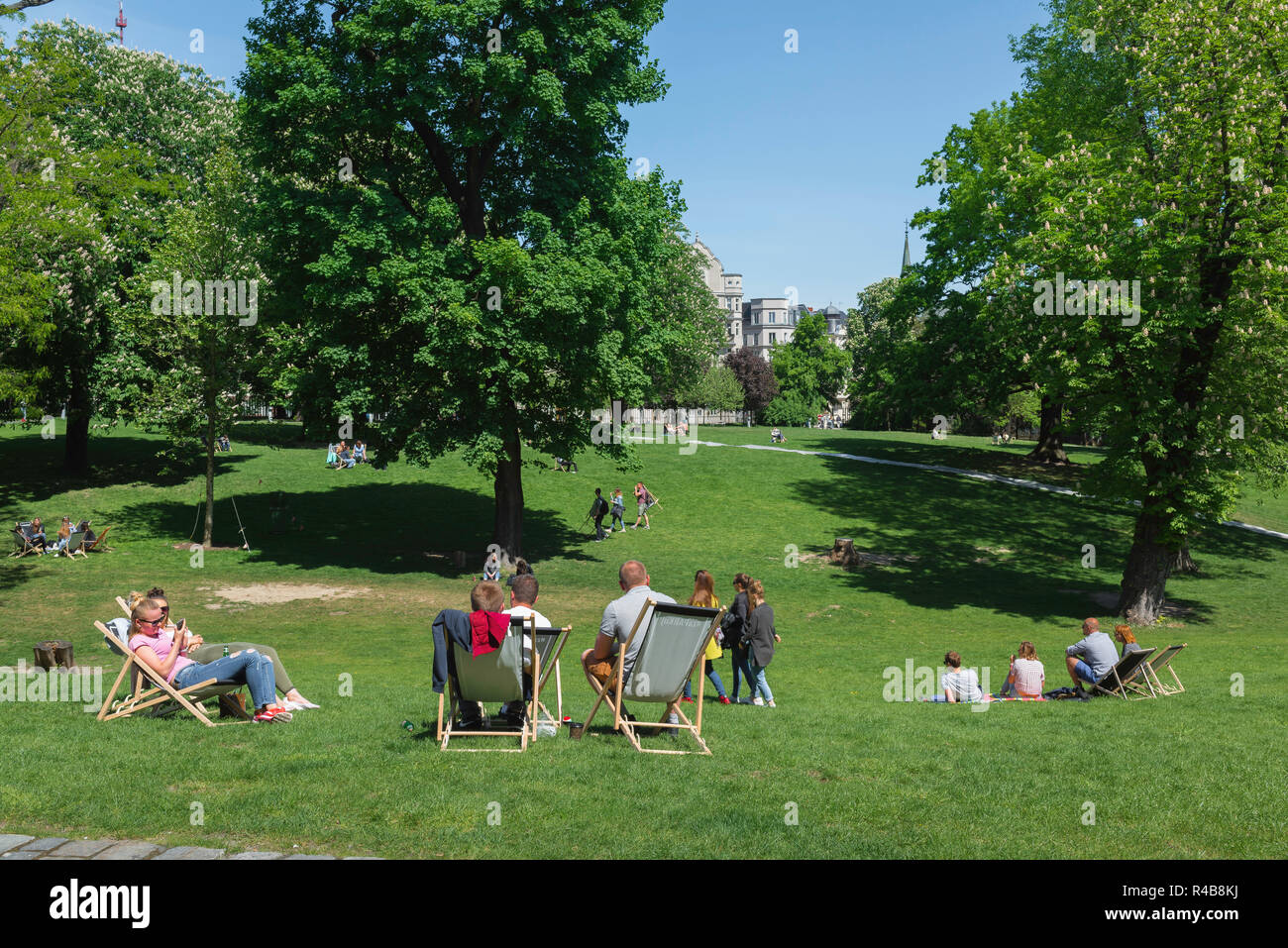 Park summer, rear view of young people relaxing in deckchairs on a summer afternoon in Dabrowskiego Park in Poznan, Poland. Stock Photo