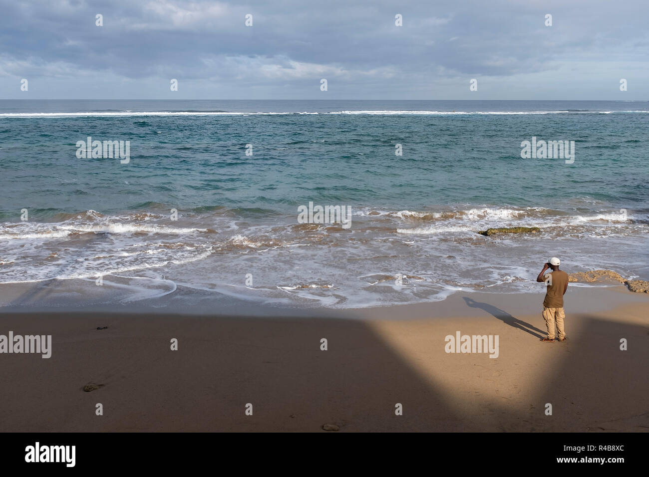 a man looking at the sea in playa de las canteras, las palmas de gran canaria, Spain Stock Photo