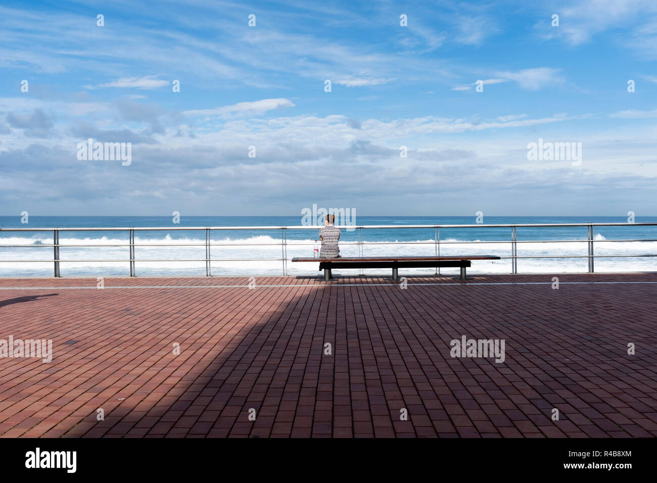 a woman looking at the sea in playa de las canteras, las palmas de gran canaria, españa Stock Photo