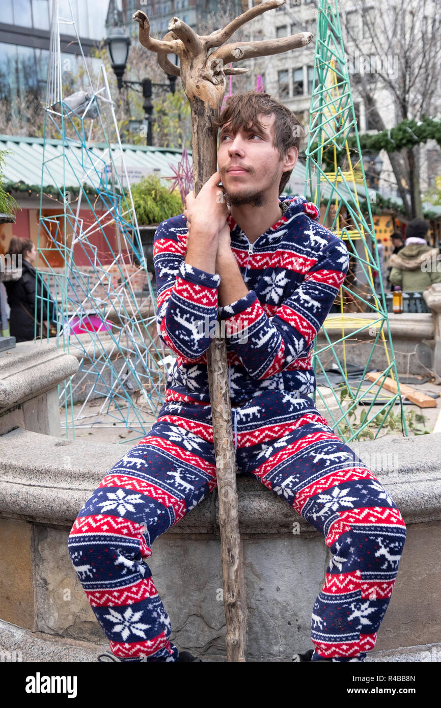 Posed portrait of a singing busker with an unusual tree branch at the Union Square Holiday Market in Lower Manhattan, New York City. Stock Photo