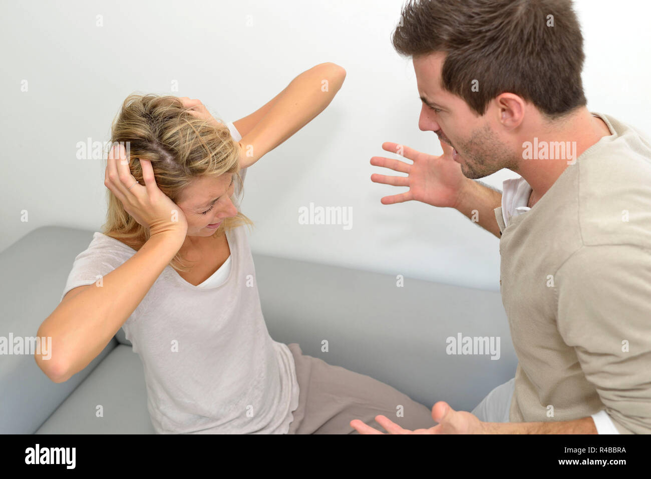 Man being angry at woman and using violence Stock Photo