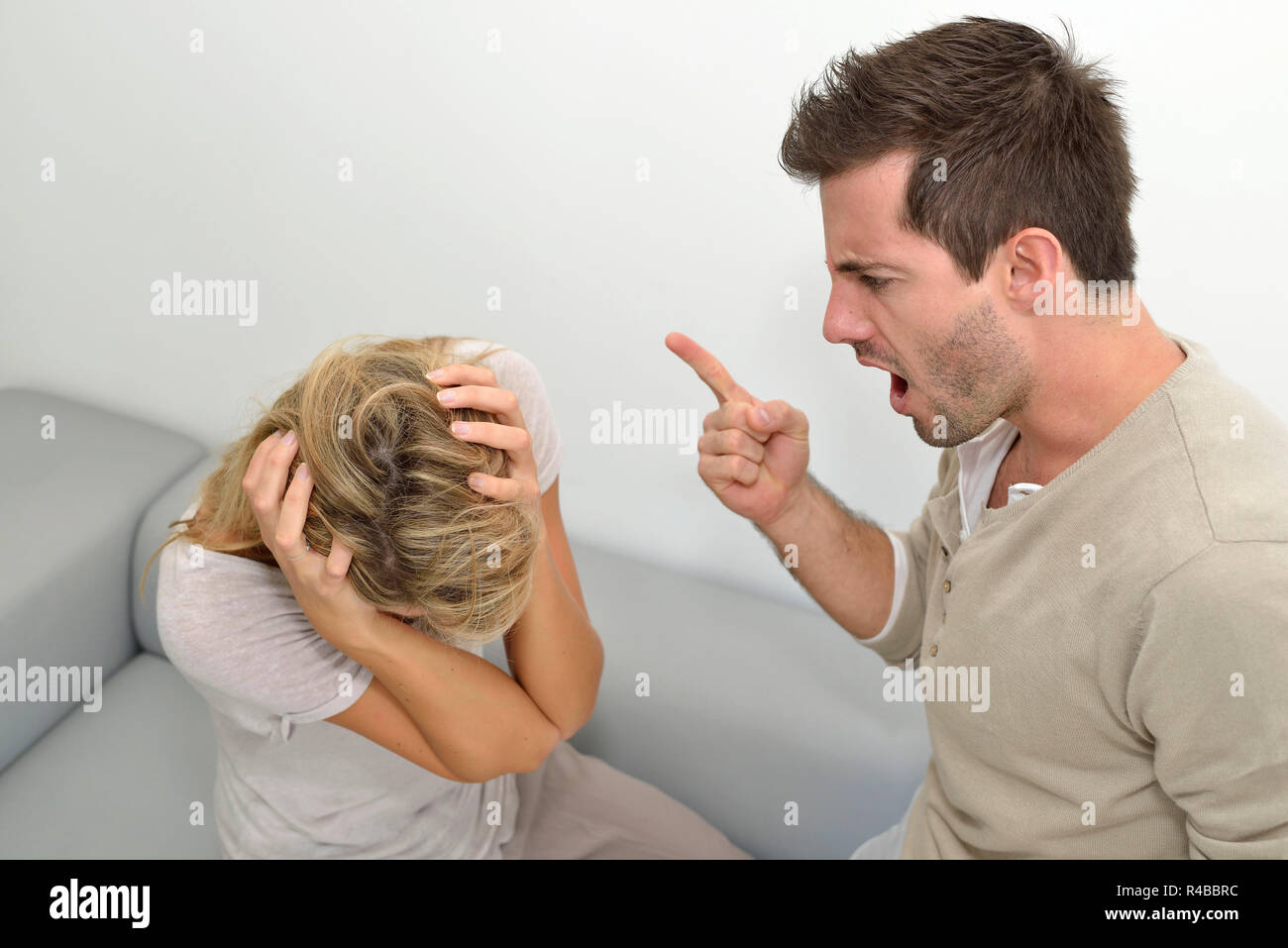 Man being angry at woman and using violence Stock Photo