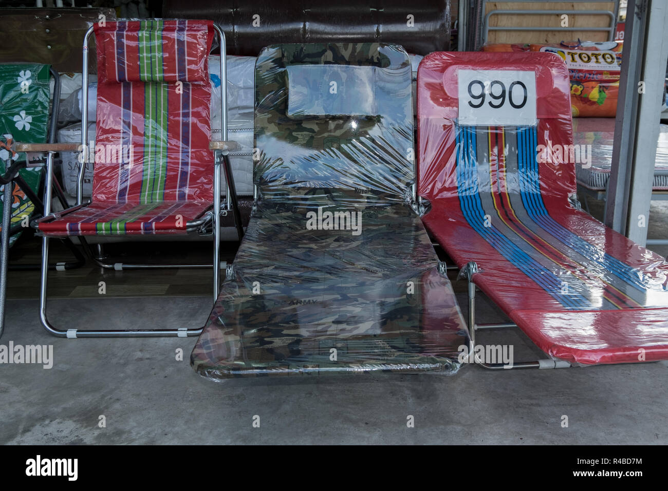 Folding chairs, including camouflage, for sale in in Hat Yai, Thailand. Stock Photo