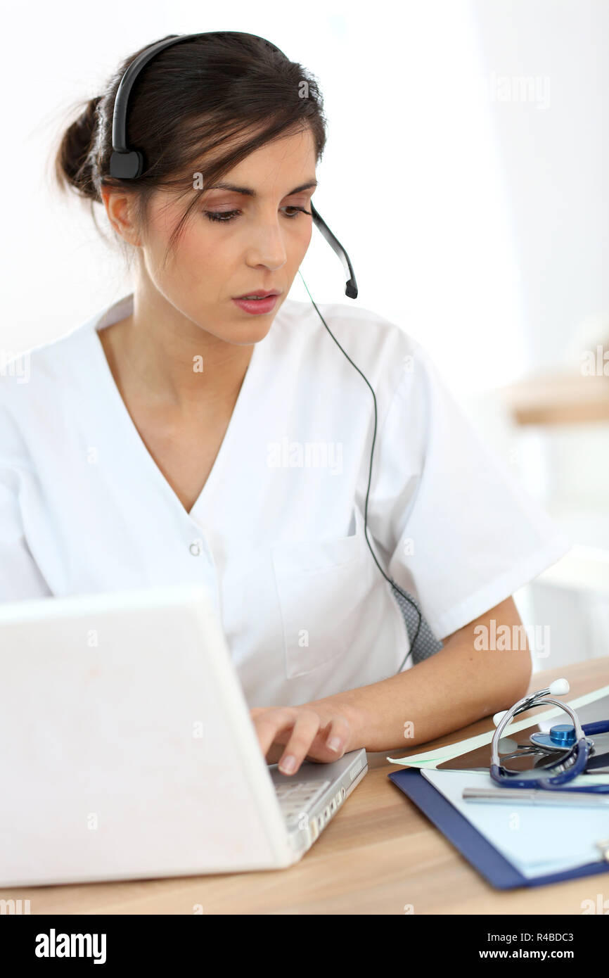 Portrait of medical secretary typing report Stock Photo Alamy