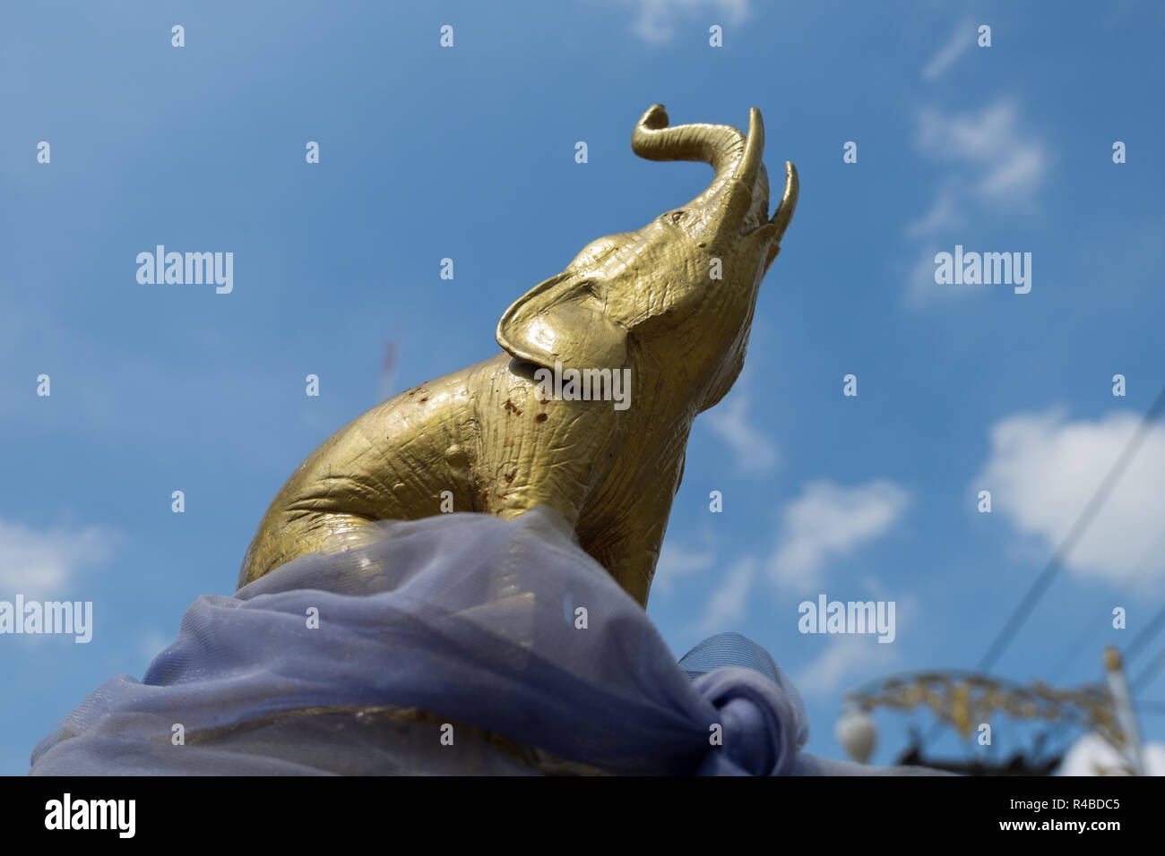 A small, gold elephant at a religious shrine in Hat Yai, Thailand. Stock Photo