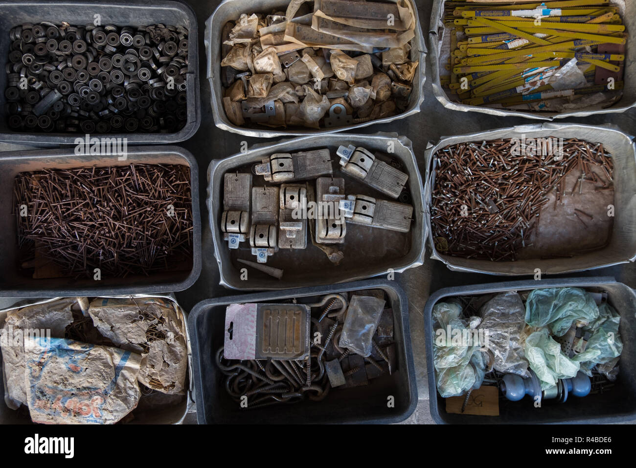 Old hardware in bins at a market in Hat Yai, Thailand. Stock Photo