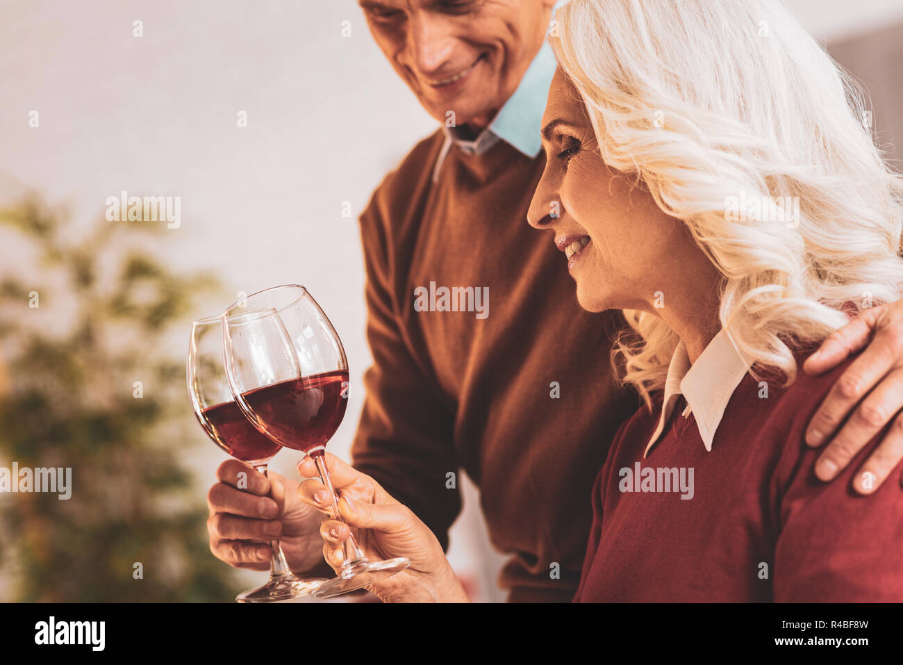 Wine evening. Couple of happy aged people feeling unforgettable while enjoying nice wine evening together Stock Photo