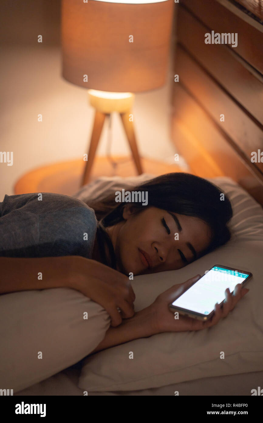 woman fell asleep after using mobile phone Stock Photo