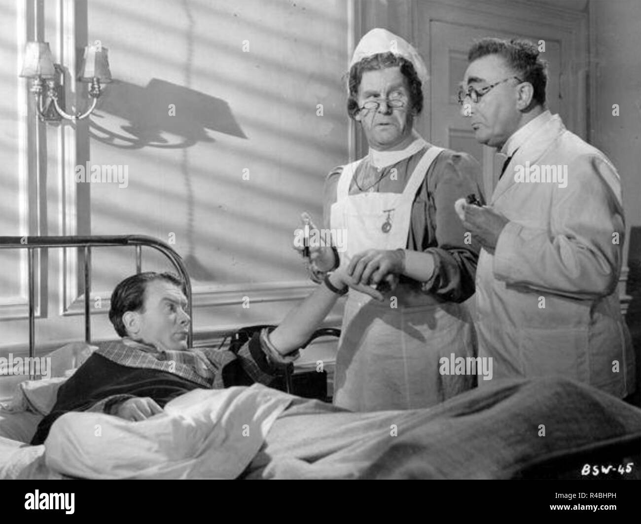 THE BLACK SHEEP OF WHITEHALL 1942 United Artists film with from left: John Mills, Will Hay, Henry Hewitt Stock Photo