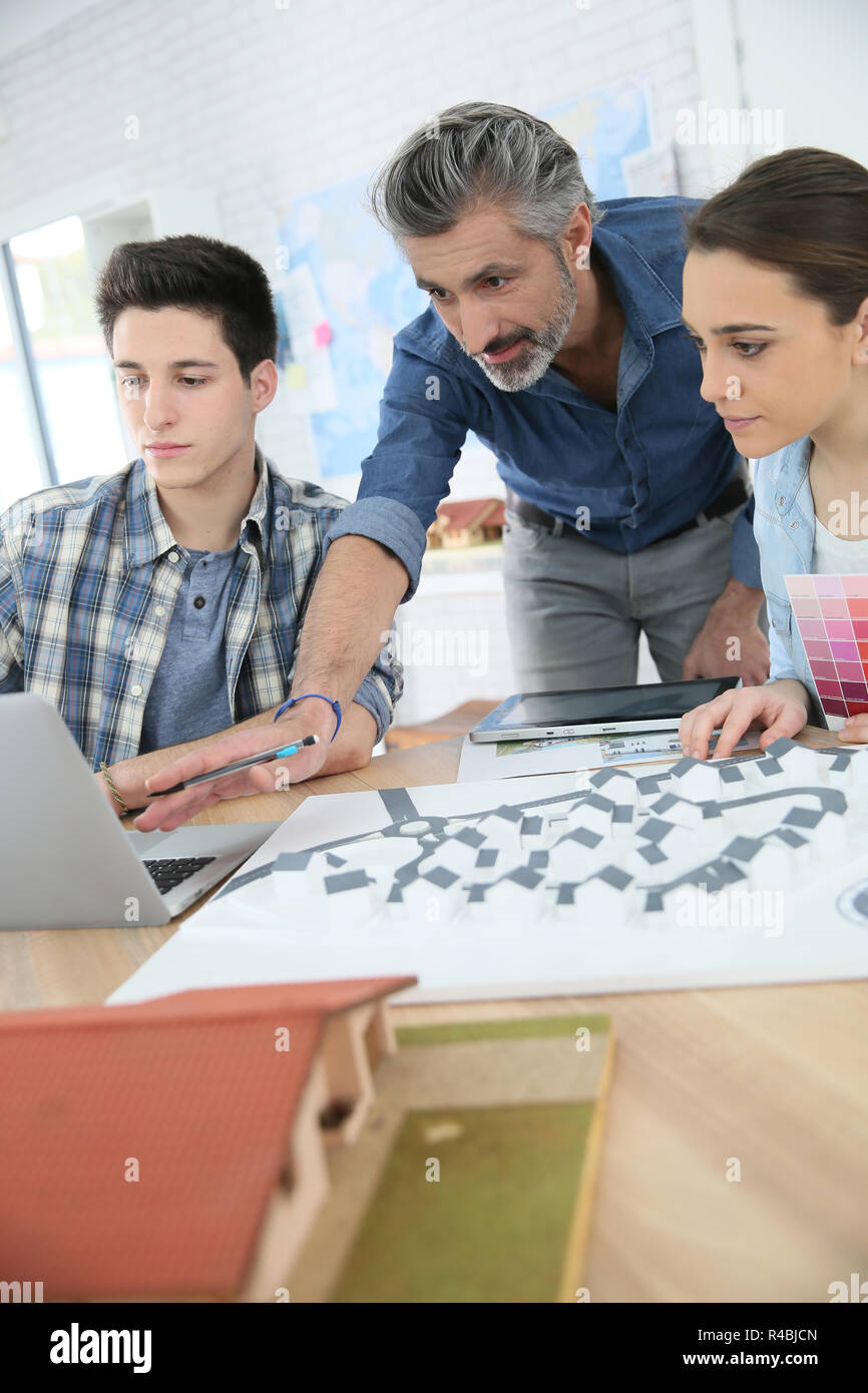 Teacher with students in architecture school Stock Photo Alamy