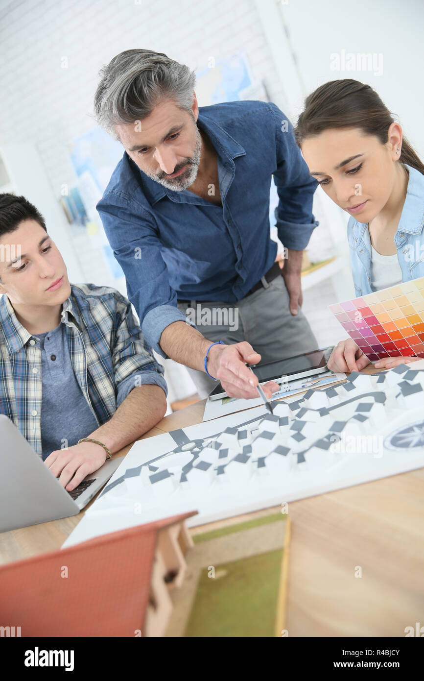 Teacher with students in architecture school Stock Photo Alamy