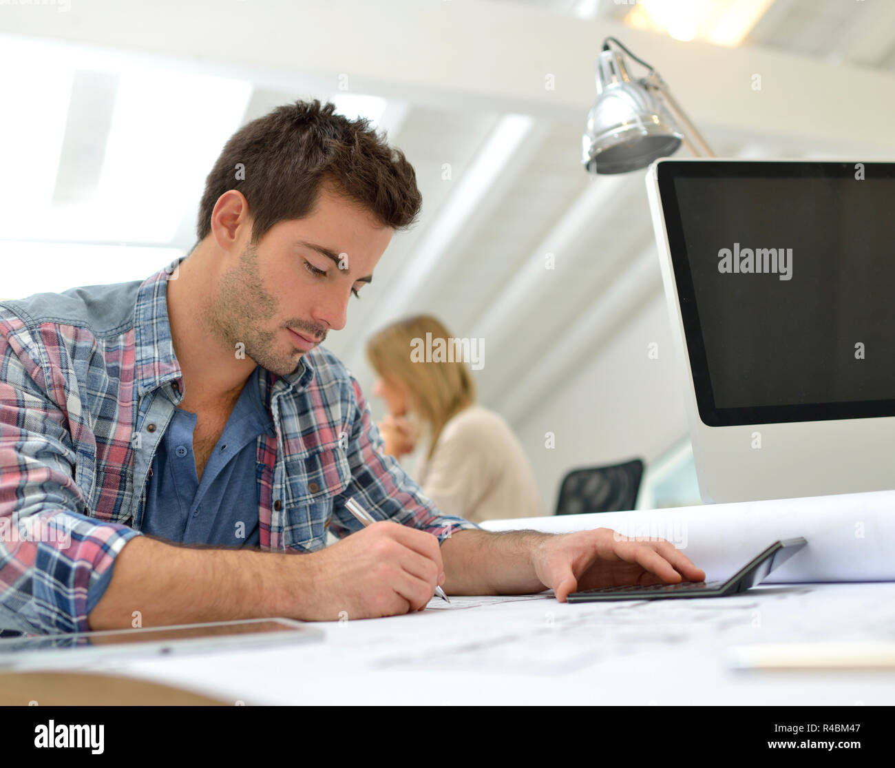 Architect working on construction budget Stock Photo Alamy