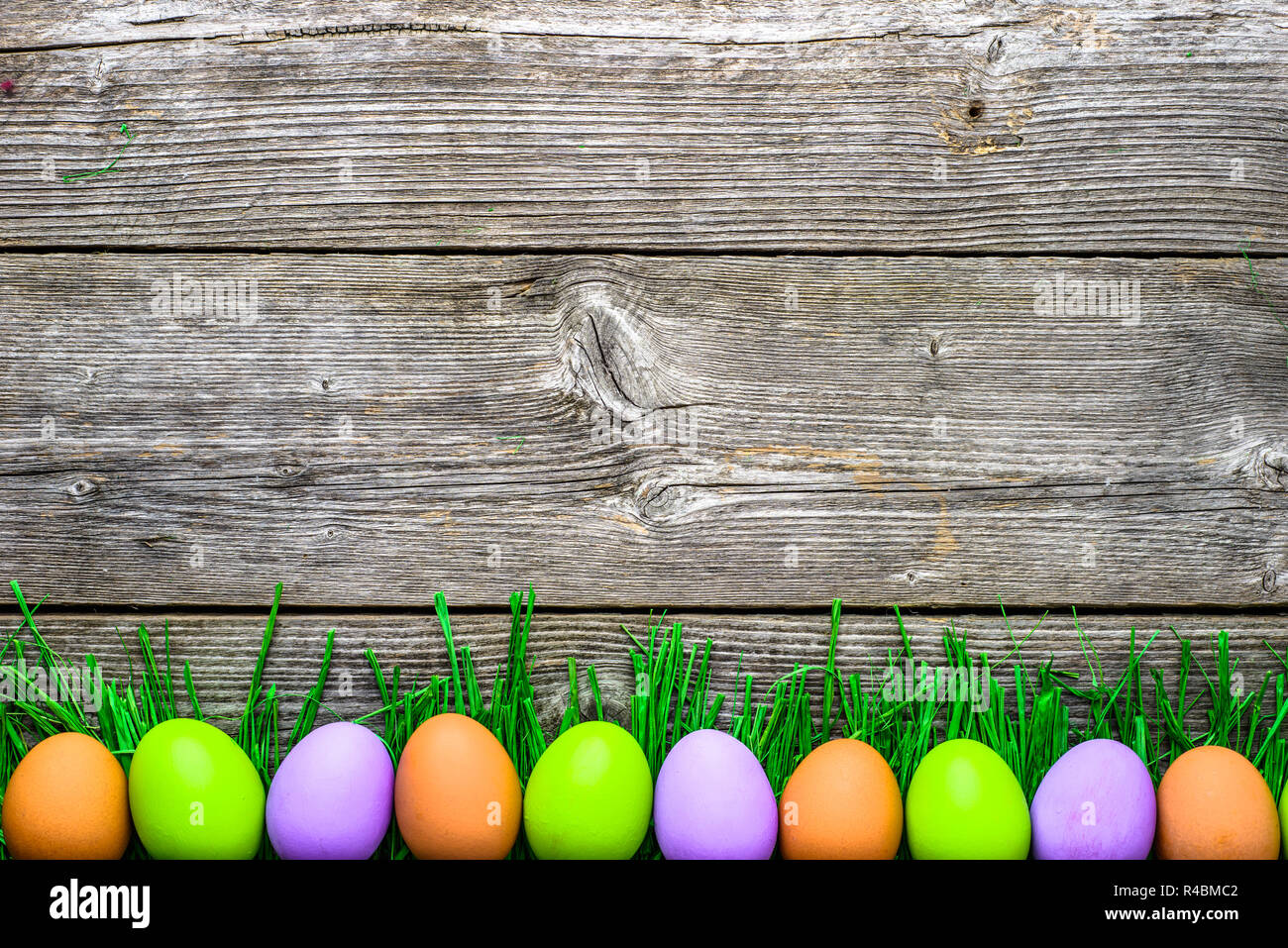 spring easter eggs background with colorful eggs on wooden easter egg background