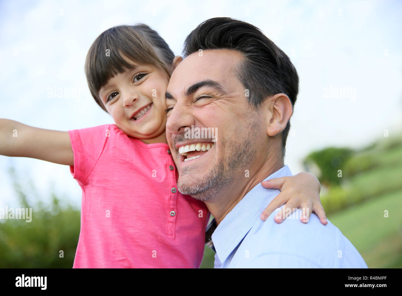 Portrait of little girl hugging her daddy Stock Photo - Alamy