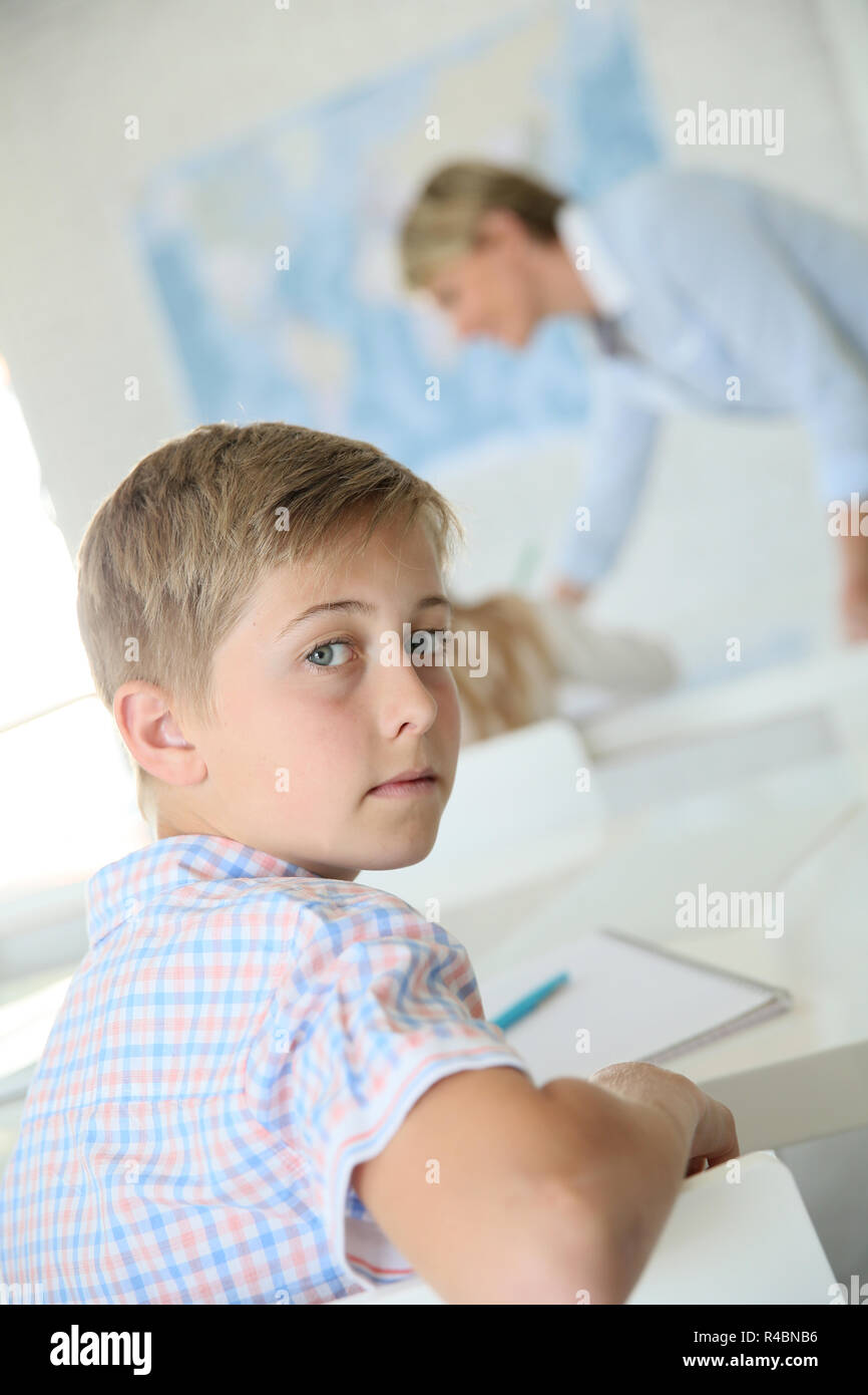 Young smiling schoolboy in classroom Stock Photo - Alamy