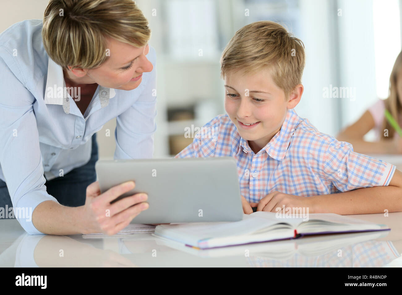 Teacher using digital tablet as educational tool in class Stock Photo ...