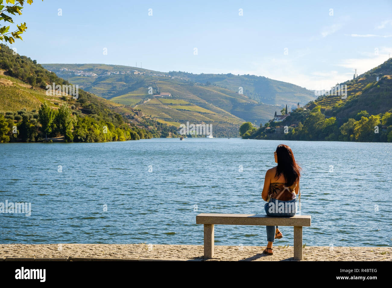 Pinhao, Portugal - October 05, 2018 : Woman admiring the beautiful landscapes on the banks of the Douro River, Vila Real, Portugal Stock Photo