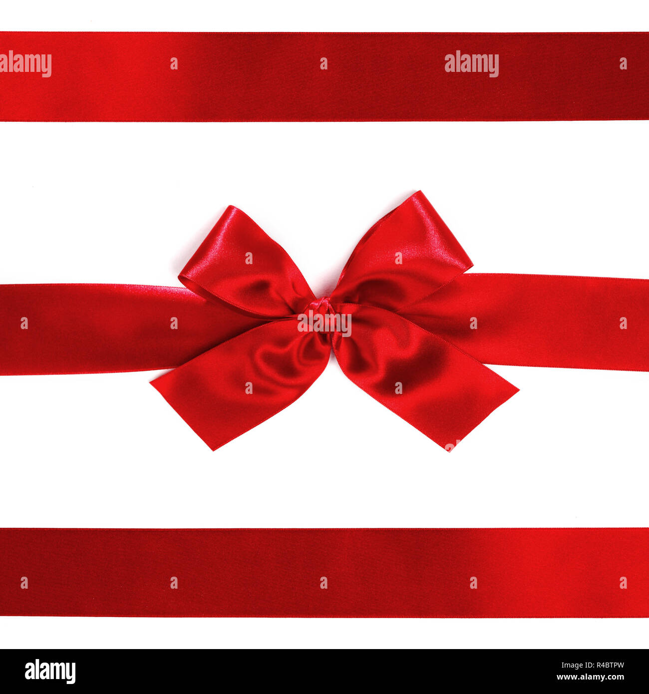 Shiny red satin ribbon decorative on white background Stock Photo - Alamy