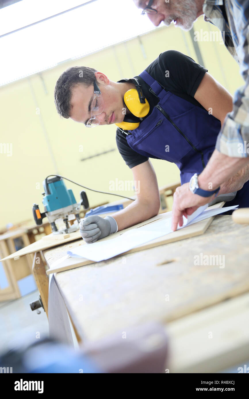 Carpenter with apprentice in training period Stock Photo