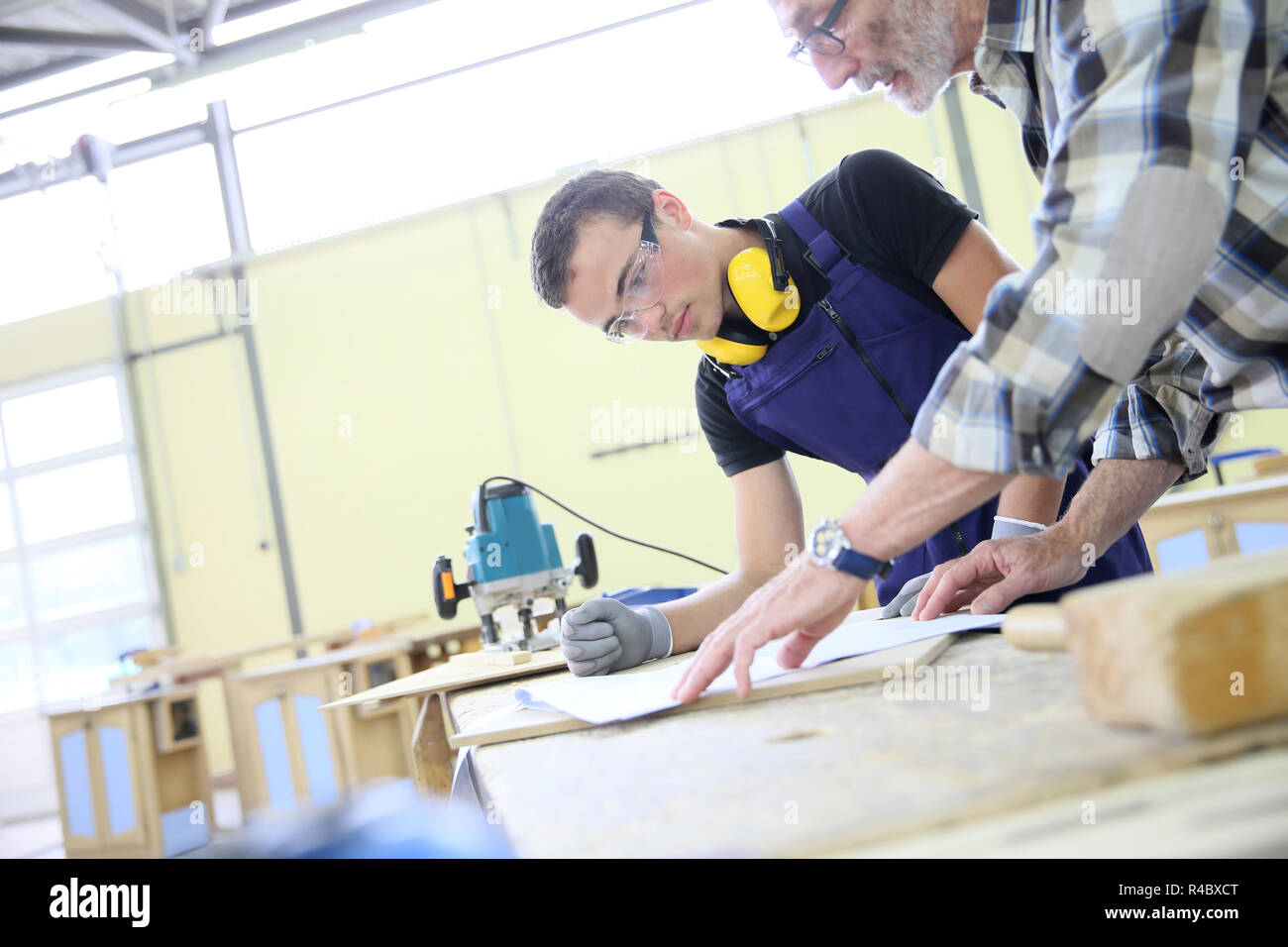 Carpenter with apprentice in training period Stock Photo