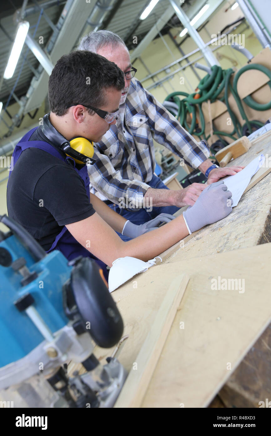 Carpenter with apprentice in training period Stock Photo