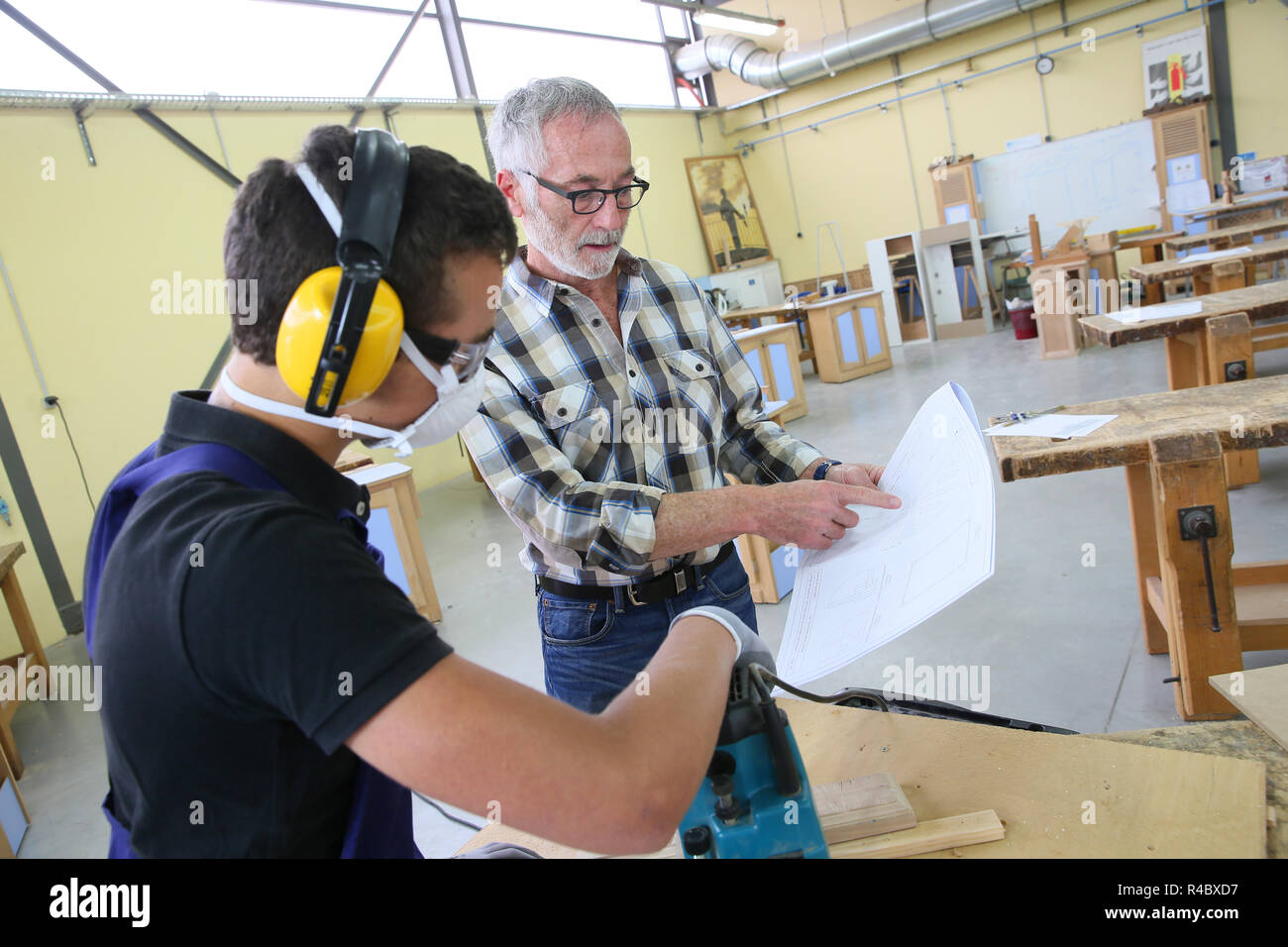 Carpenter with apprentice in training period Stock Photo