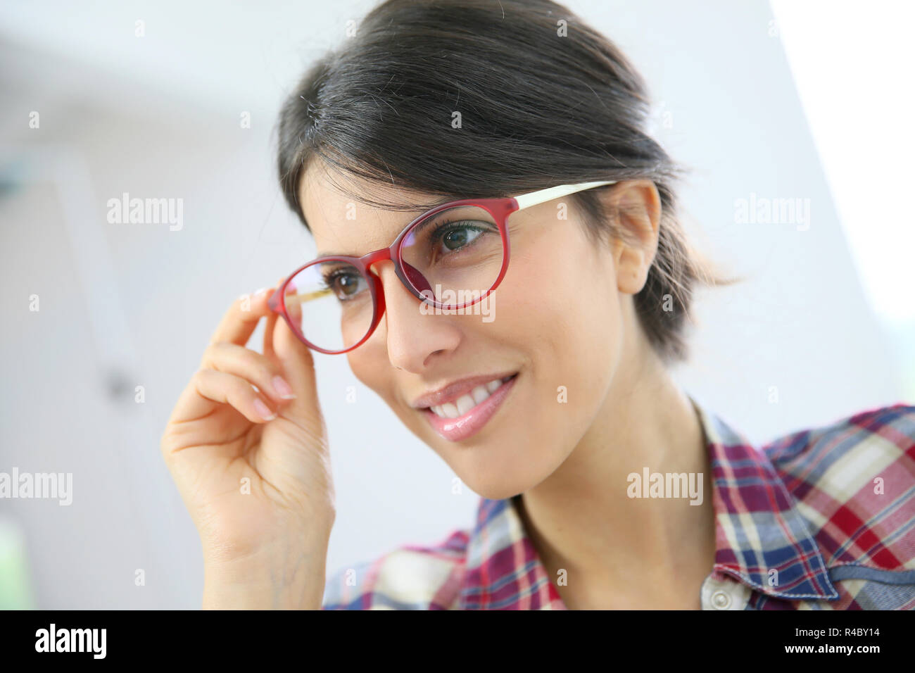 Portrait of brunette girl with red eyeglasses on, isolated Stock Photo