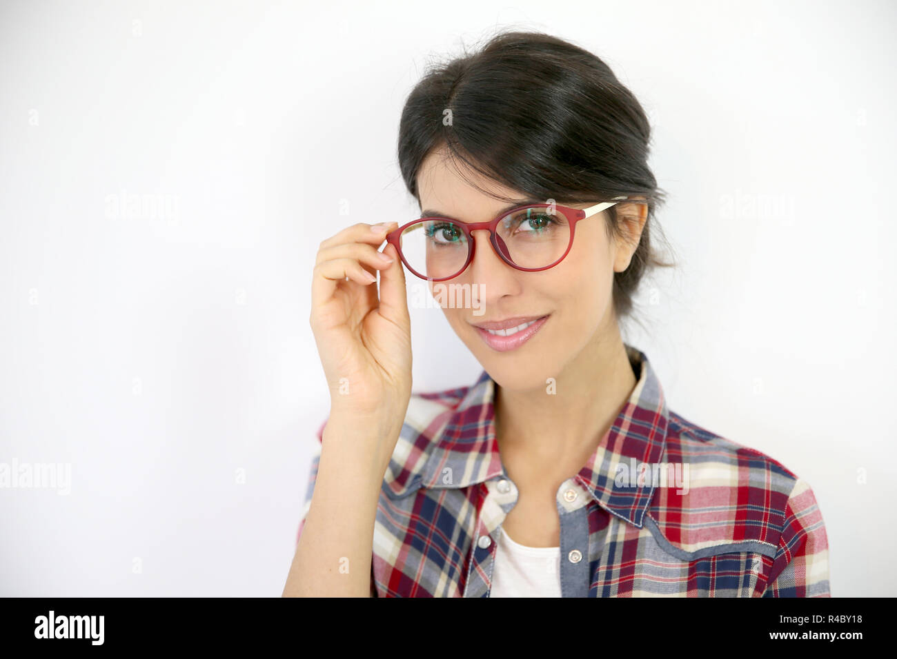 Portrait of brunette girl with red eyeglasses on, isolated Stock Photo