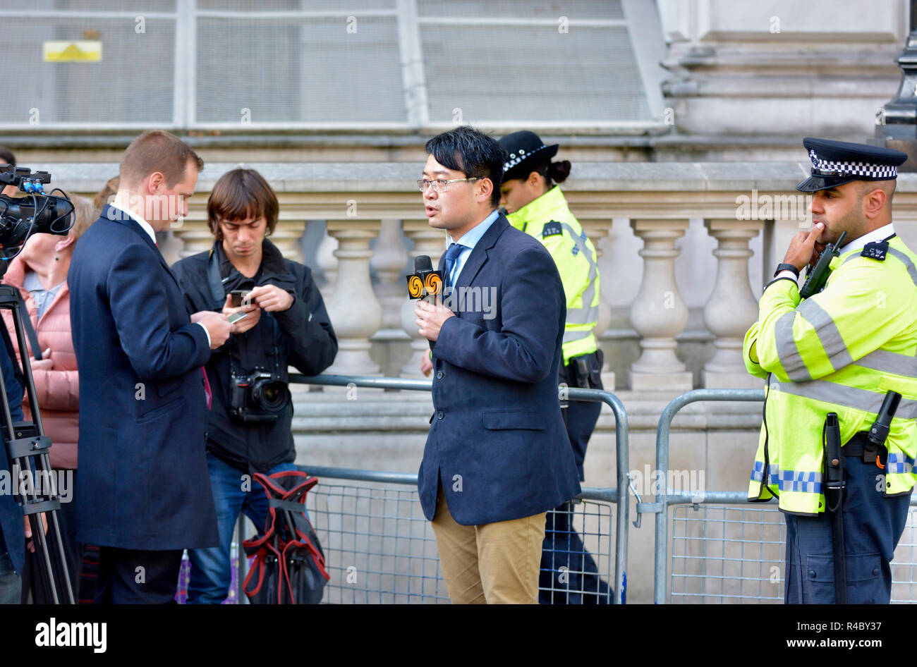 Phoenix TV (Hong Kong) reporter outside Downing Street, London, England