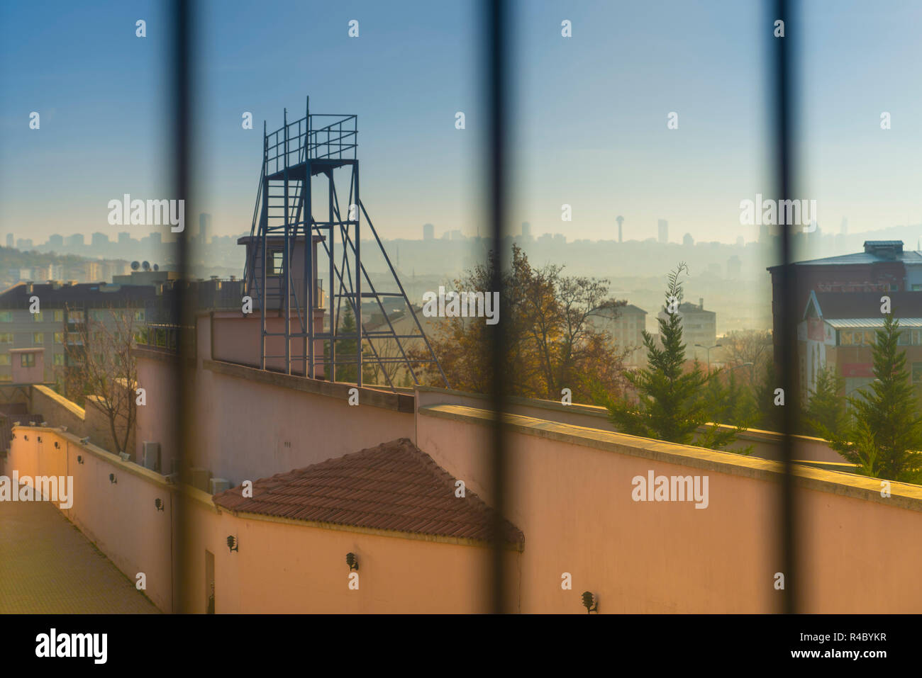 Ankara/Turkey-November 25 2018:  Behind the bars in Ulucanlar prison and Ankara silhouette in background. This jail part as known 'Hilton' for popular Stock Photo
