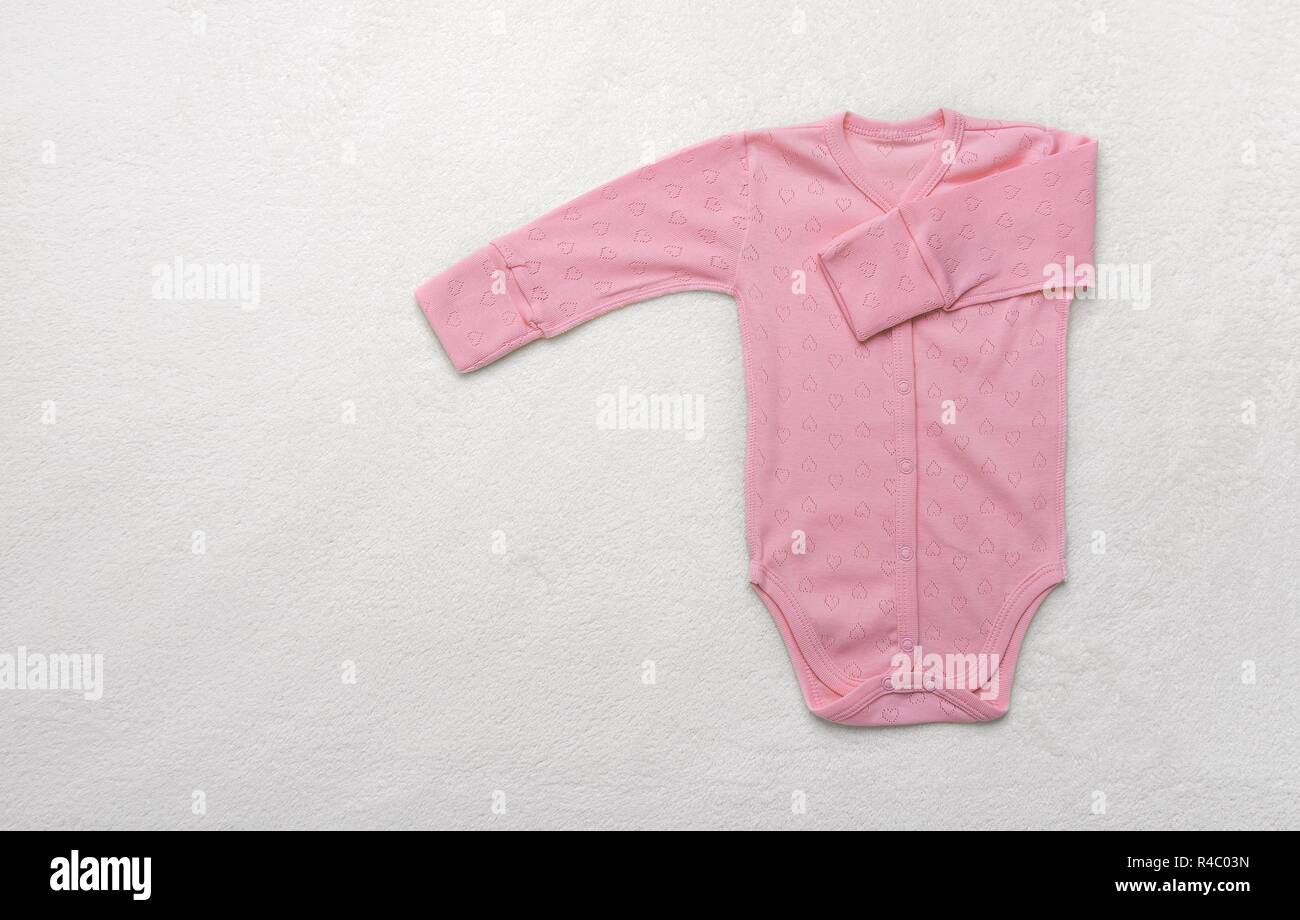 Children's clothing for toddlers. Photographed on a light plush blanket. Stock Photo