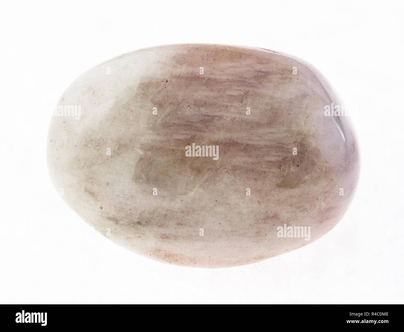 macro photography of natural mineral from geological collection - tumbled albite (moonstone) gemstone on white background Stock Photo