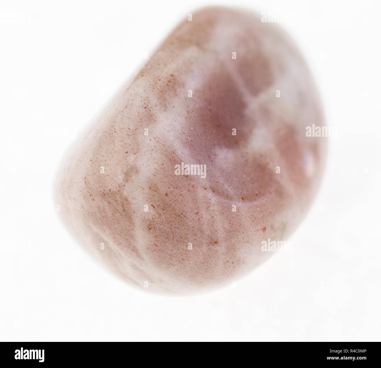 macro photography of natural mineral from geological collection - polished albite (moonstone) gemstone on white background Stock Photo