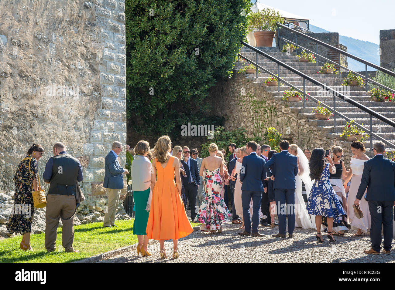 A couple celebrates the outdoor wedding in the Scaliger Castle of the medieval town of Malcesine on Lake Garda, northern Italy. Stock Photo