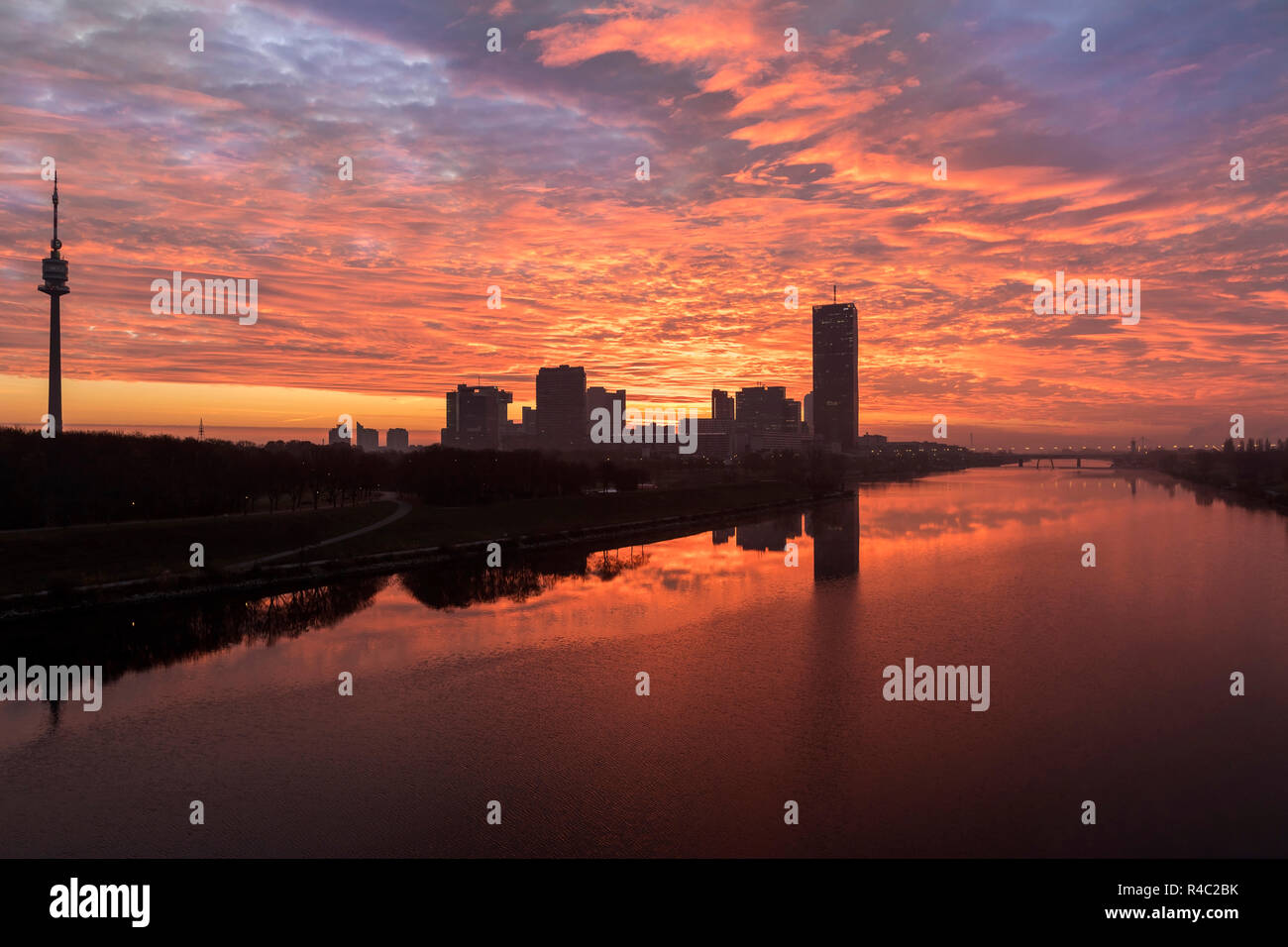 Atmospheric sunrise at the so called Danube Island in Vienna with the amazing skyline of Danube City at the Danube River - Austria. Stock Photo