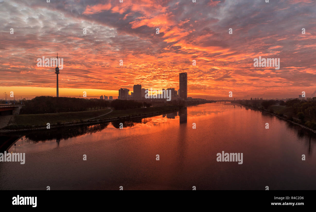 Atmospheric sunrise at the so called Danube Island in Vienna with the amazing skyline of Danube City at the Danube River - Austria. Stock Photo