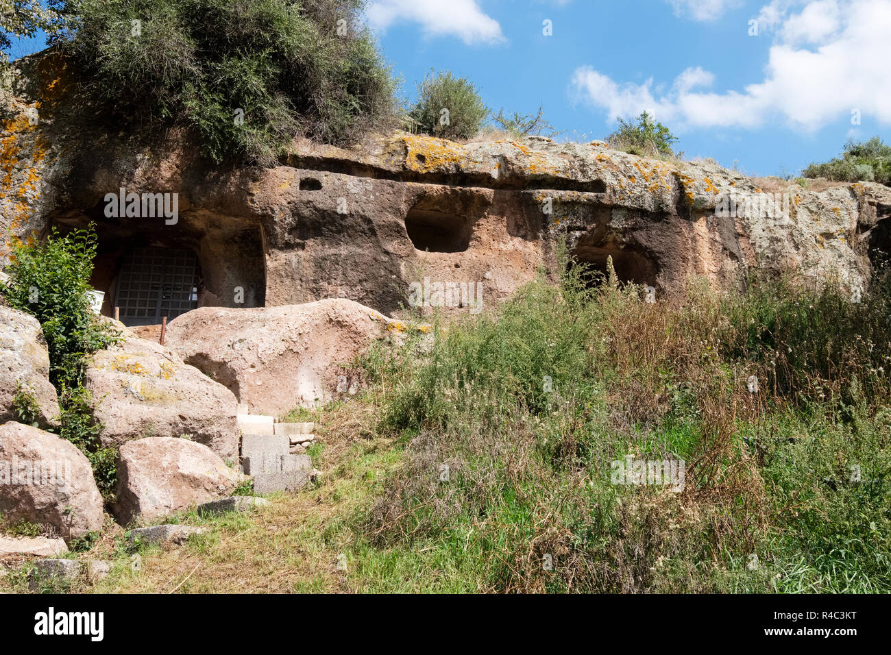 Domus de Janas, 'houses of the fairies'. Neolithic hypogeal tombs, volcanic rock (trachyte}. Necropolis Sant' Andrea Priu complex. Bonorva, Sardinia Stock Photo