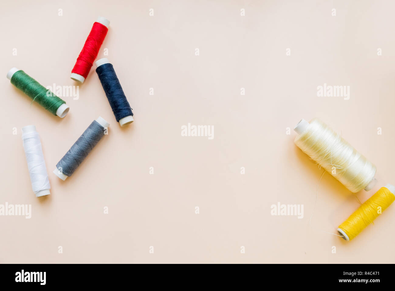 Hanks of multi-coloured threads for embroidery on pastel background.multi colored embroidery thread yarns. Flat lay of colored thread rolls for sewing, Sewing and needlework concept.Copy space Stock Photo