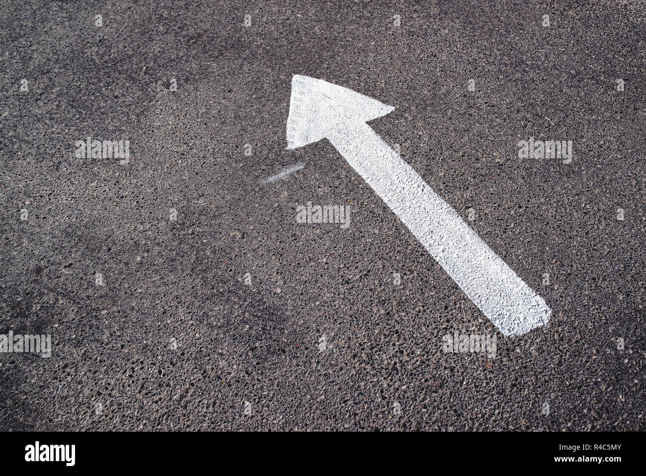 Direction arrow symbol on the road with copy space Stock Photo