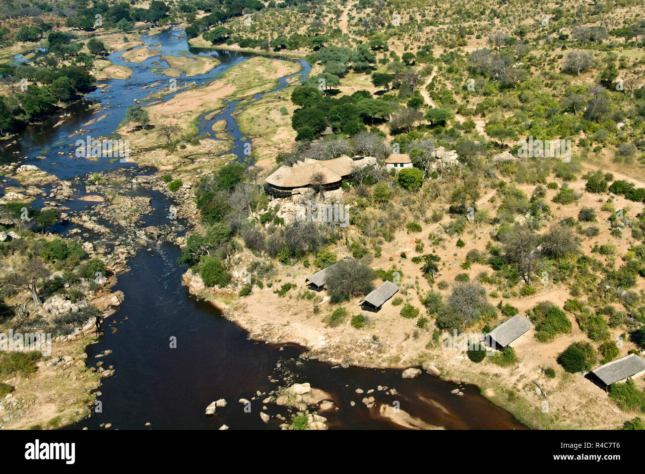 The aerial view of the main public area of Ruaha River Camp, overlooking the rapids on the Great Ruaha River Stock Photo