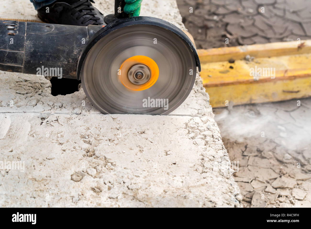 Close up worker cuts concrete with circular saw Stock Photo