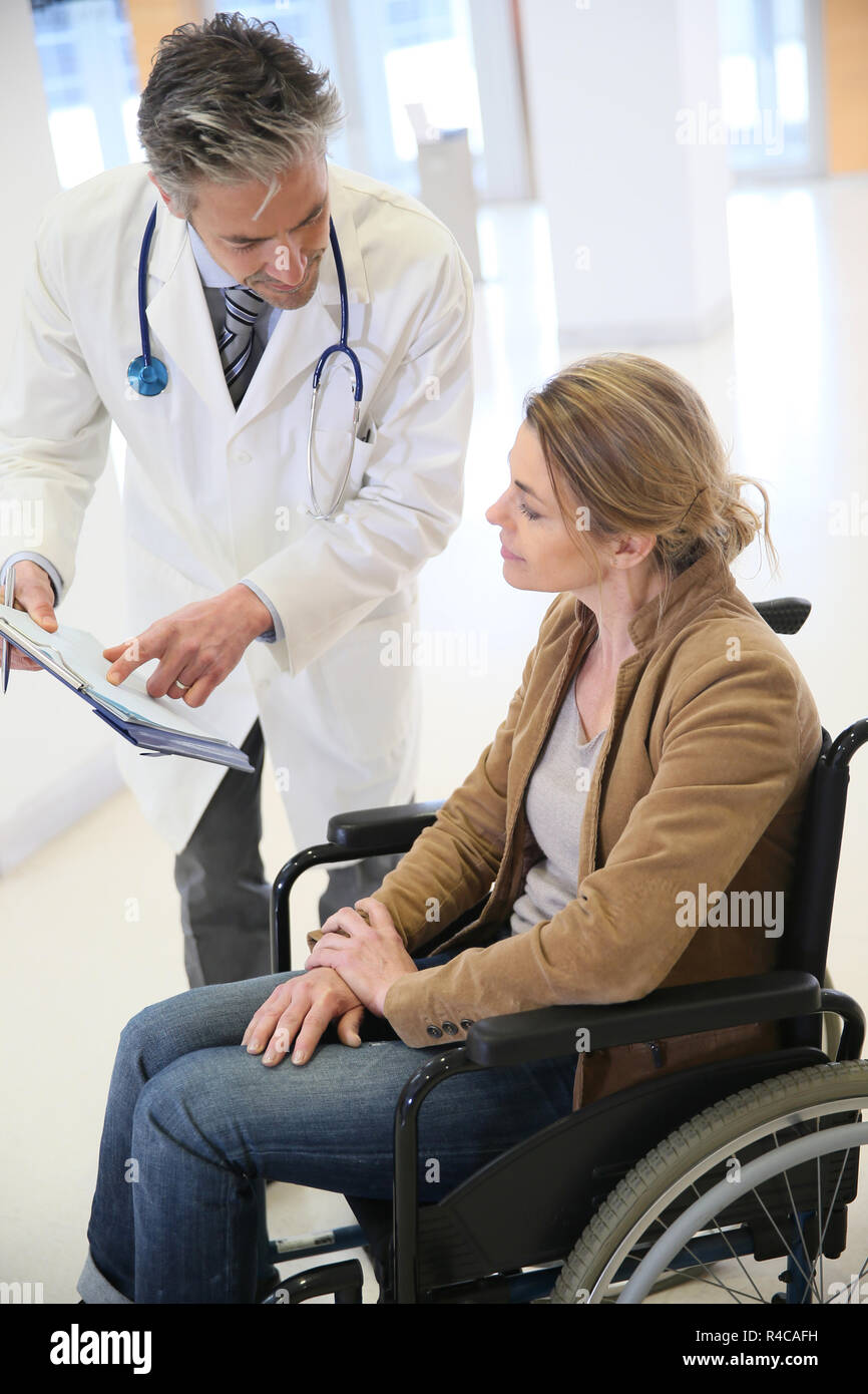 Doctor talking to woman in wheelchair after surgery Stock Photo Alamy