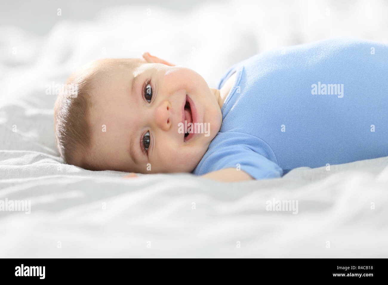 8monthold baby boy laying on bed Stock Photo Alamy