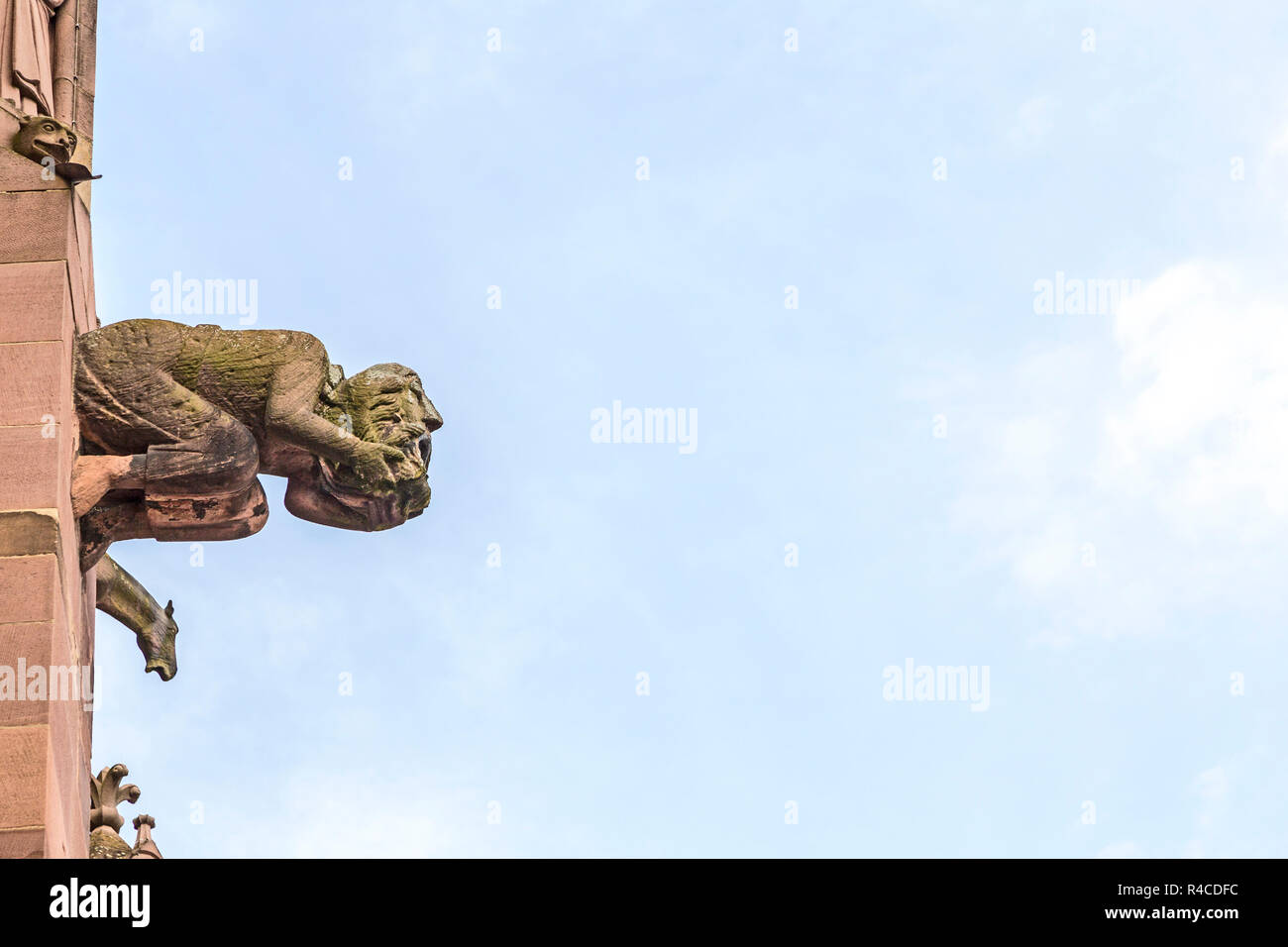 Figure of a gargoyle at Muenster in Freiburg, Germany Stock Photo. 