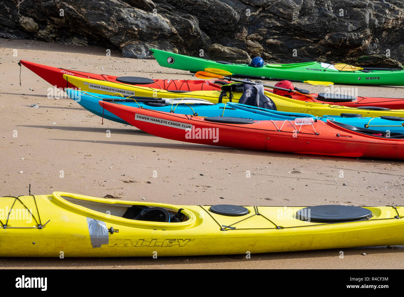Canoes on the beach at Gara Rock beach, South Devon Stock Photo Alamy