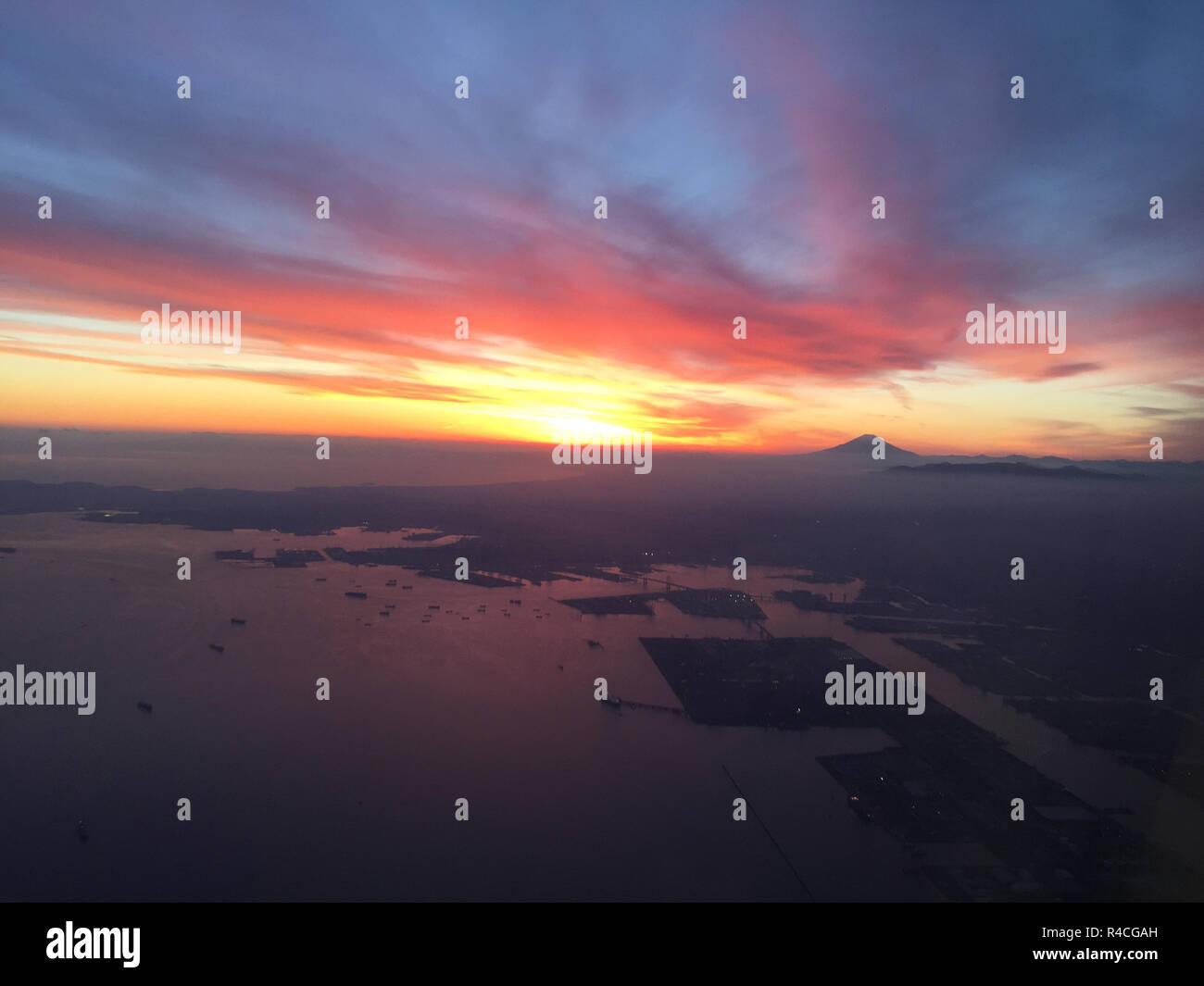 JAPAN Flying into Nagasaki airport with Mt Fuji silhouetted in the distance at right. Stock Photo