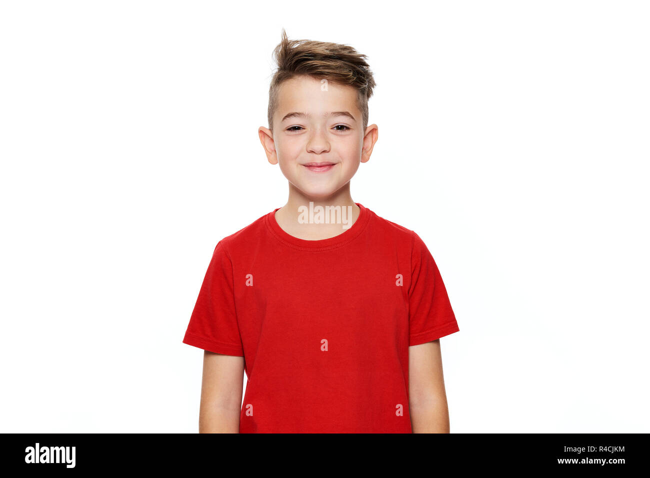Adorable young teenage boy waist up studio portrait isolated over white