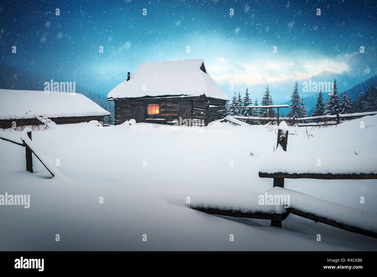 Fantastic winter landscape with wooden house in snowy mountains. Christmas holiday concept. Carpathians mountain, Stock Photo